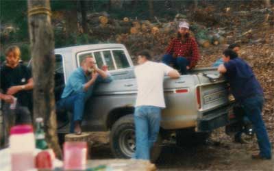 Men gather around a pickup truck