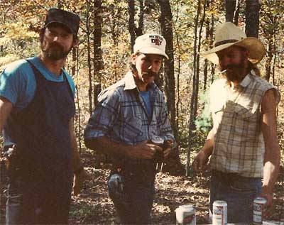 Three men in the woods drinking beer