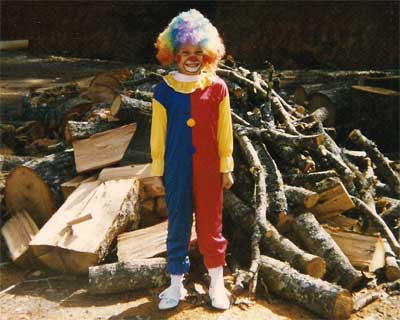 Little clown by the woodpile