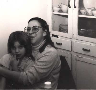 Erika and Maria beside old kitchen cabinet