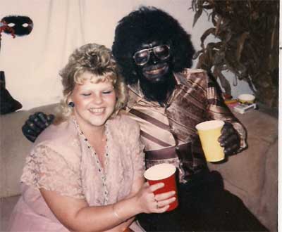 man in black face with fancy woman