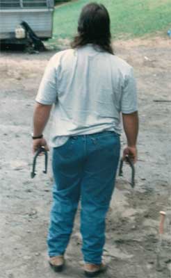 Timmy prepares to throw some horseshoes.