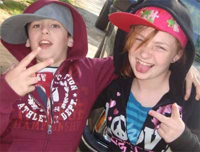 two young people shooting peace signs