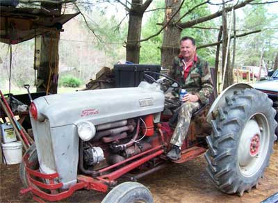 man on old Ford tractor