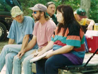 People sit on a tailgate to watch the games.