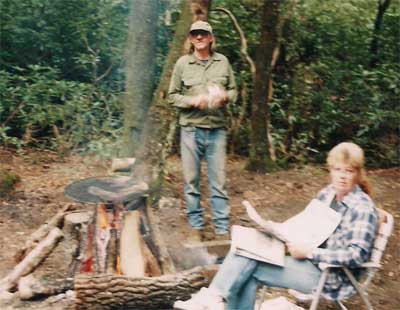 Gwen and Gomer camping in the woods