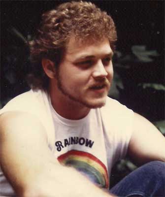 man with rainbow shirt