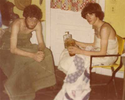 two men at a toga party with liquor