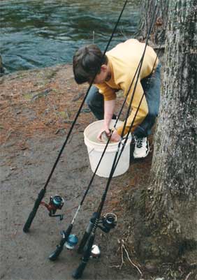 boy with trout in bucket